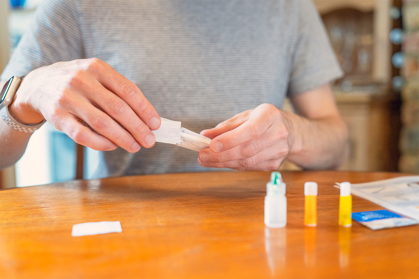 A person opens and looks at a rapid covid test.