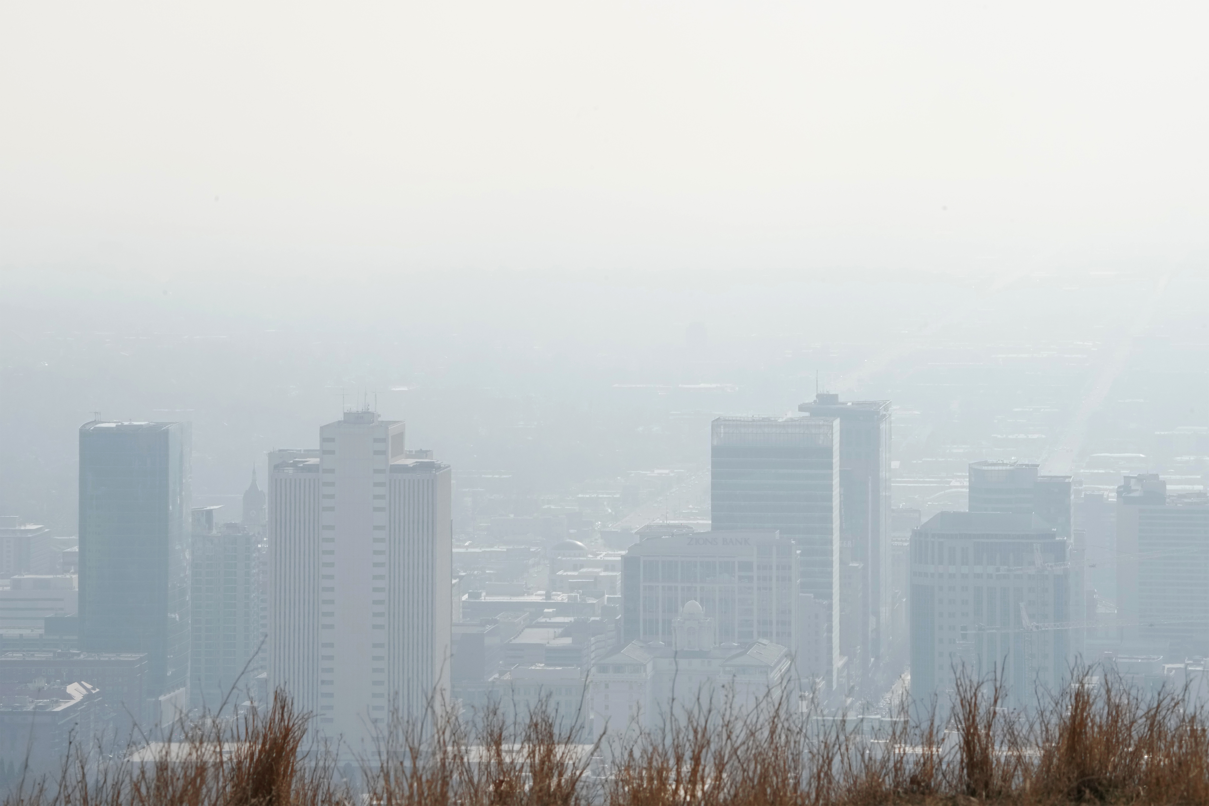 A photo shows a city skyline obscured by thick smog.