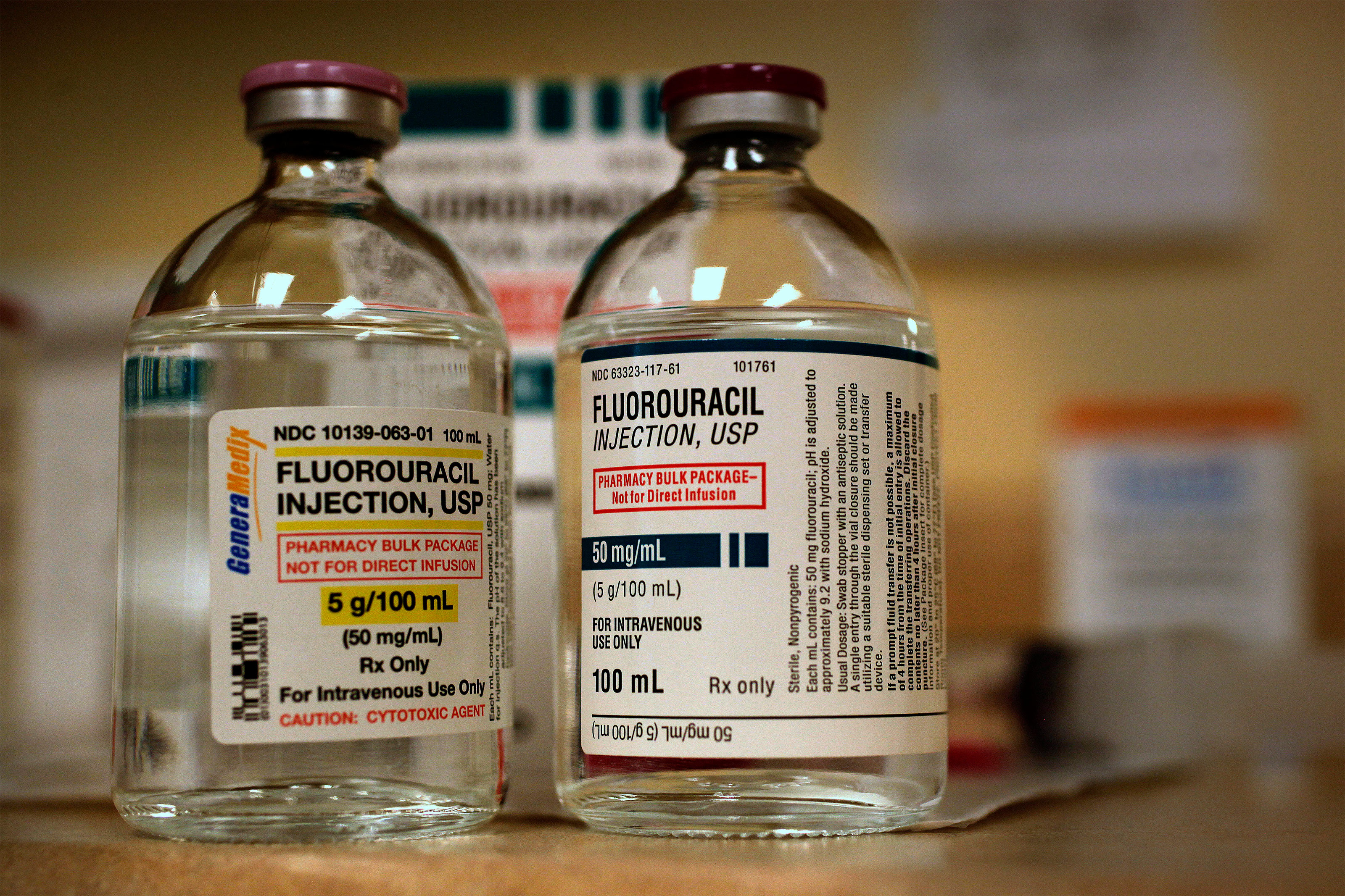 Two bottles of clear medical fluid labeled fluorouracil, for IV use only.