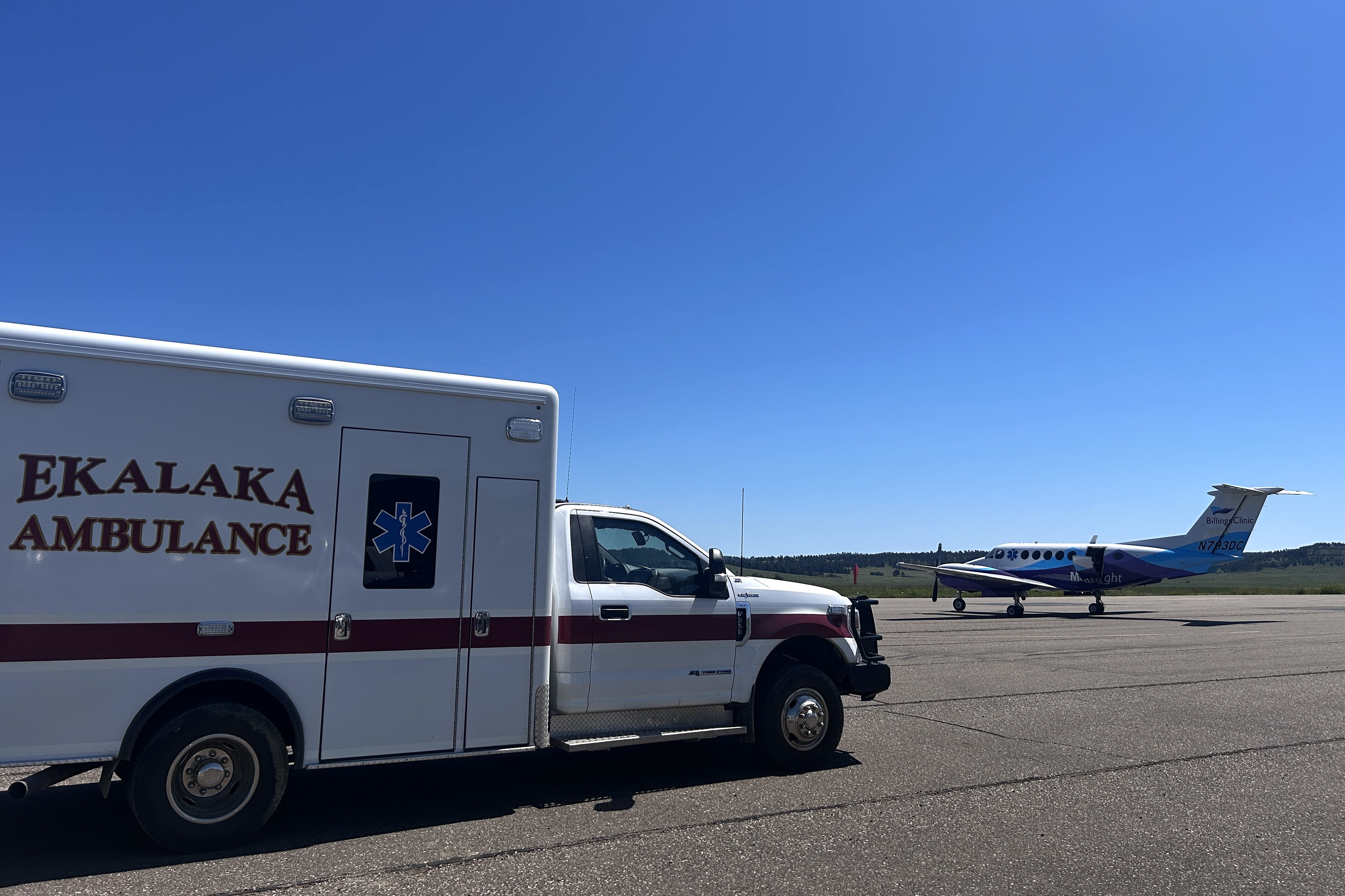 An ambulance driving along a rural road