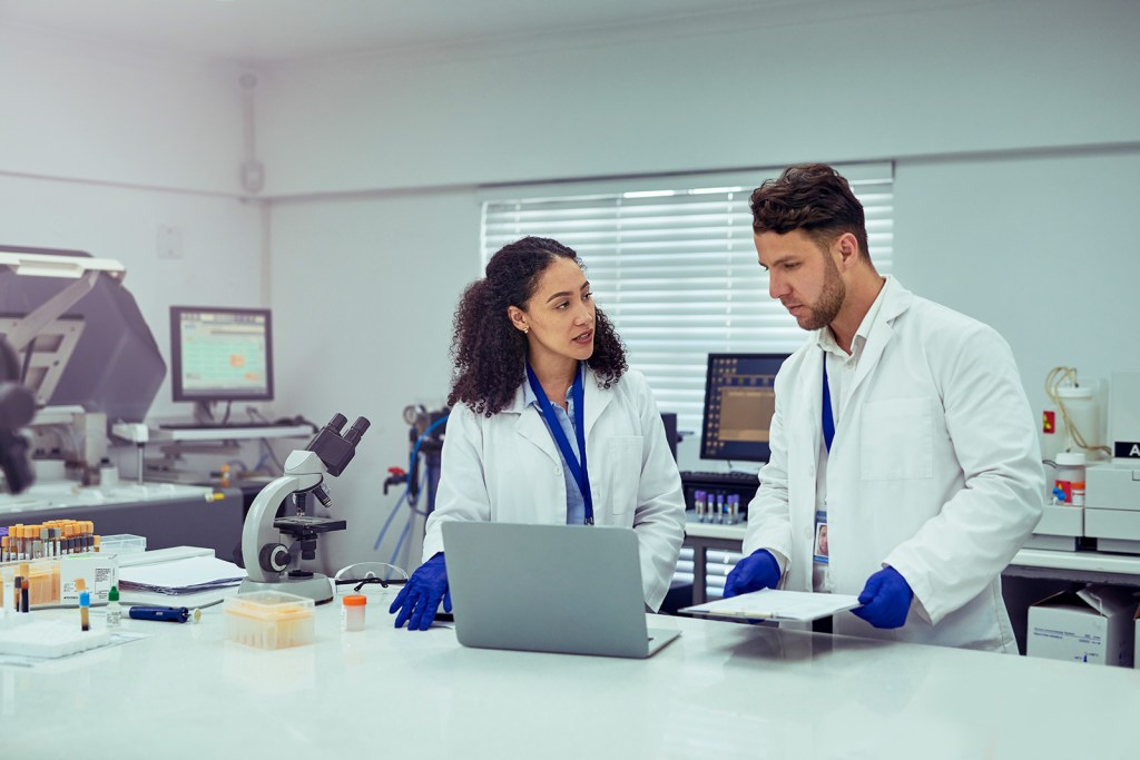 A photograph of two scientists working in a lab