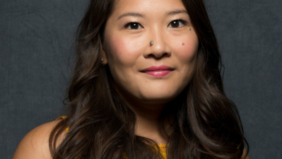 Photo of Christine Mai-Duc in a yellow top against a gray background