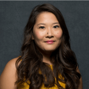 Photo of Christine Mai-Duc in a yellow top against a gray background