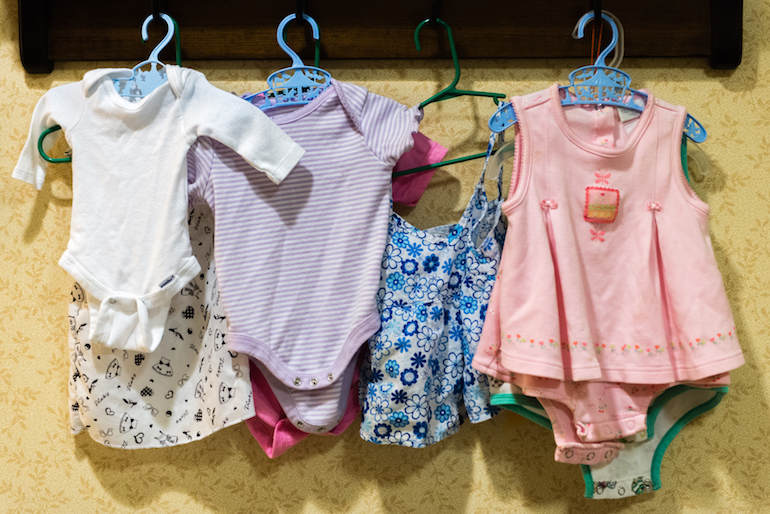 Baby clothes hang on the wall of the nursery area at Sunrise Senior Living in Beverly Hills, California, on August 2, 2016. The nursing home has dedicated a section of the facility for residents participating in doll therapy. (Heidi de Marco/KHN)