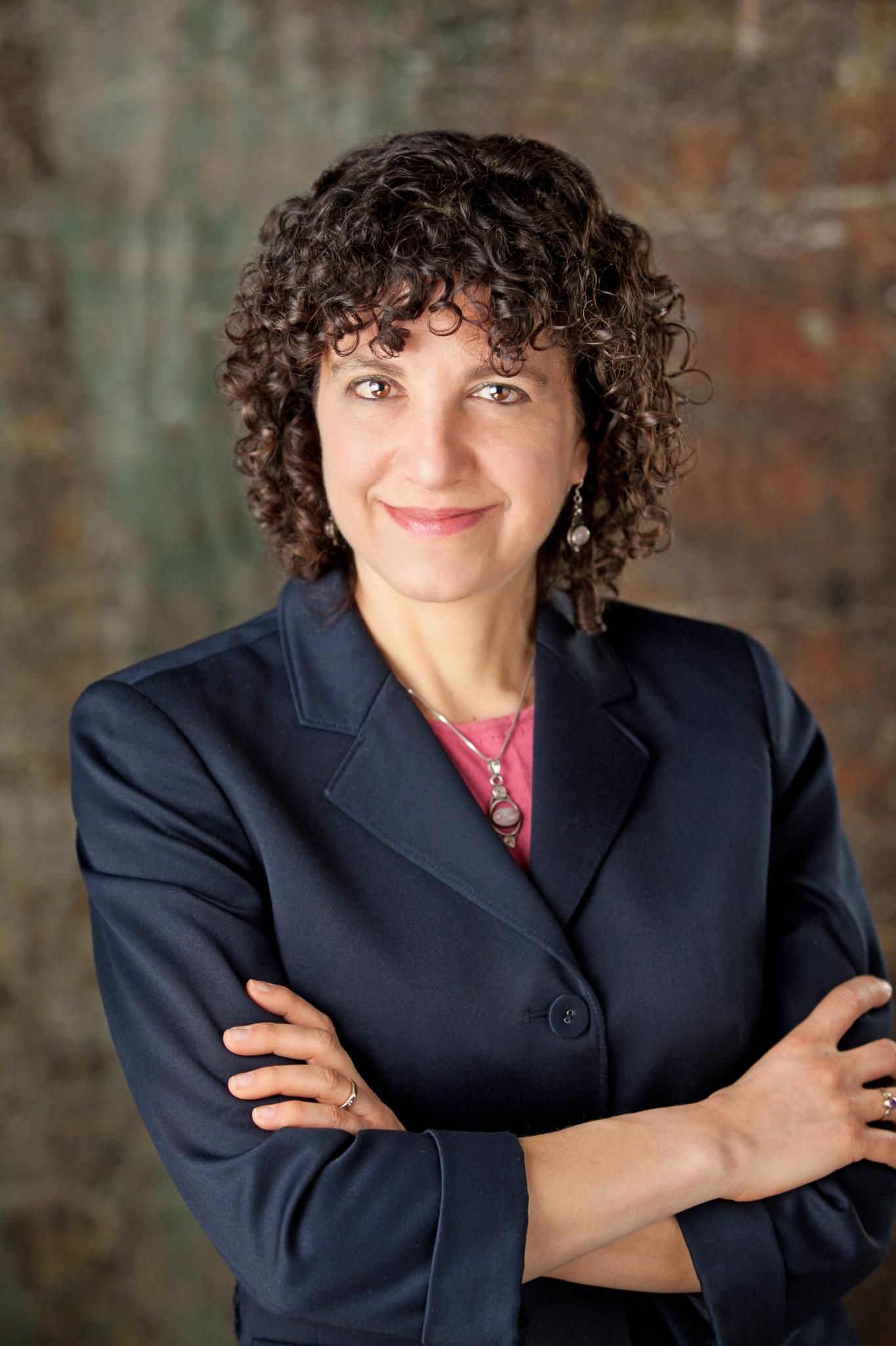 Becca Levy poses for a portrait with her arms crossed.