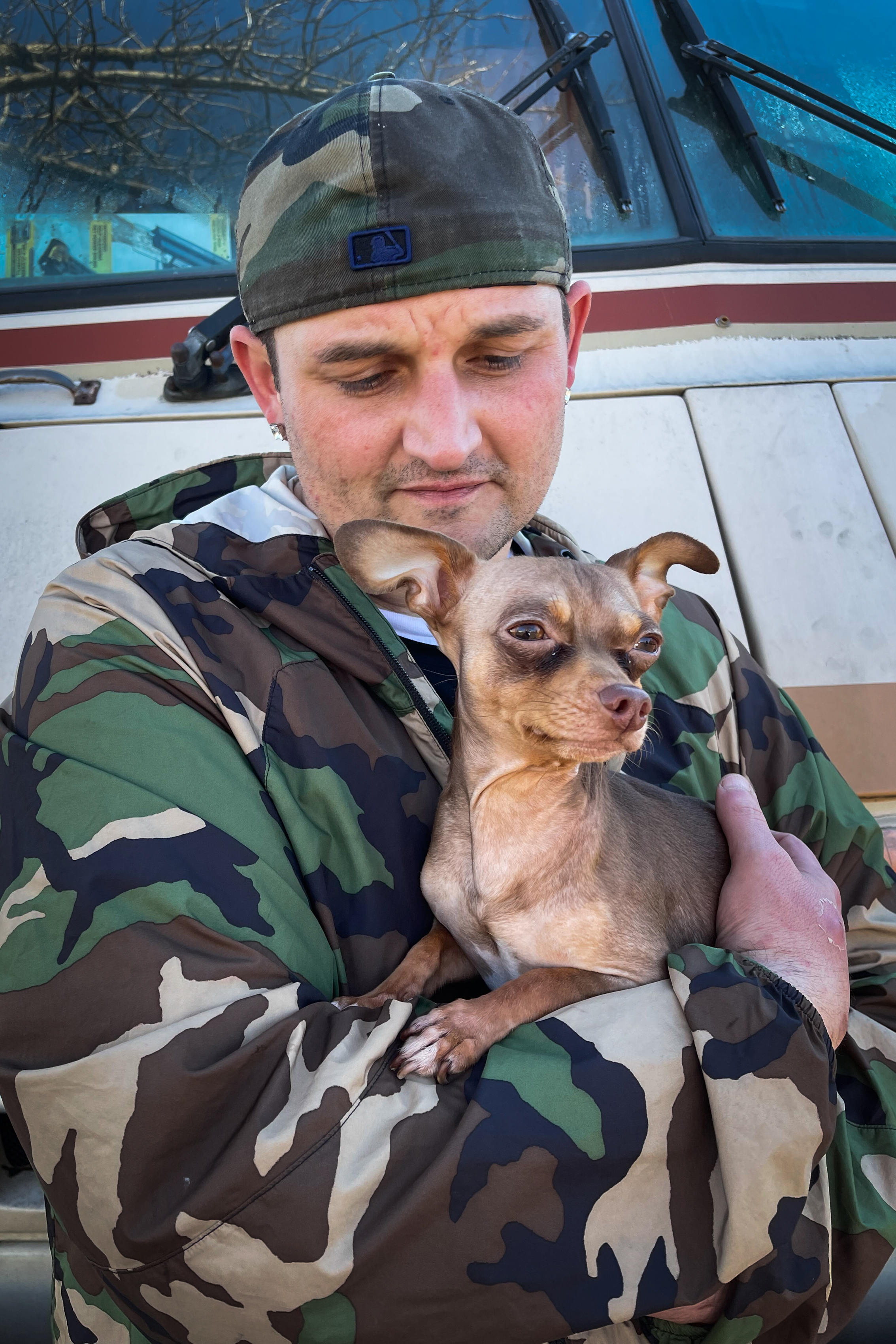 A photo shows Larry Bixel holding a dog.