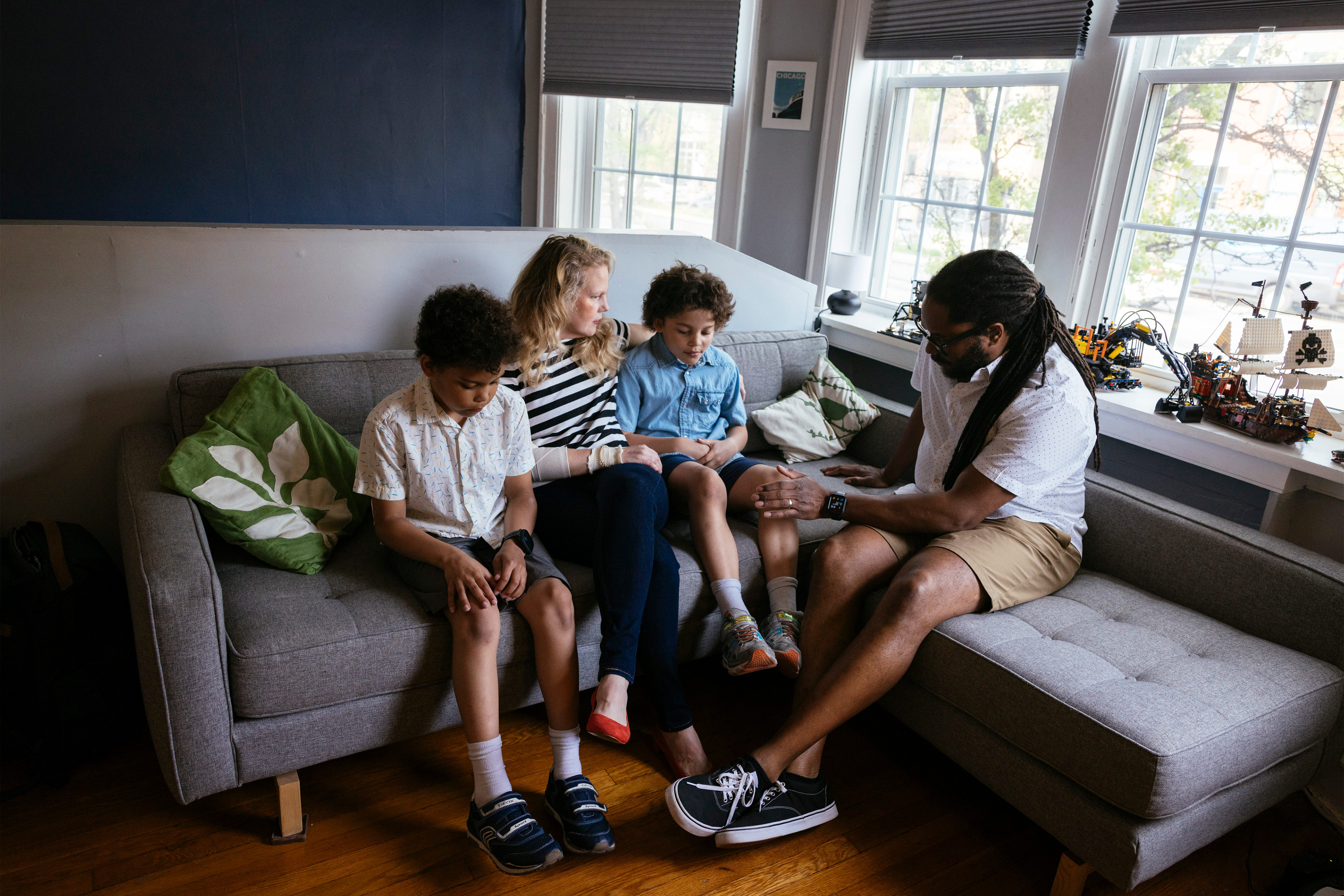 A family sitting together on a couch.