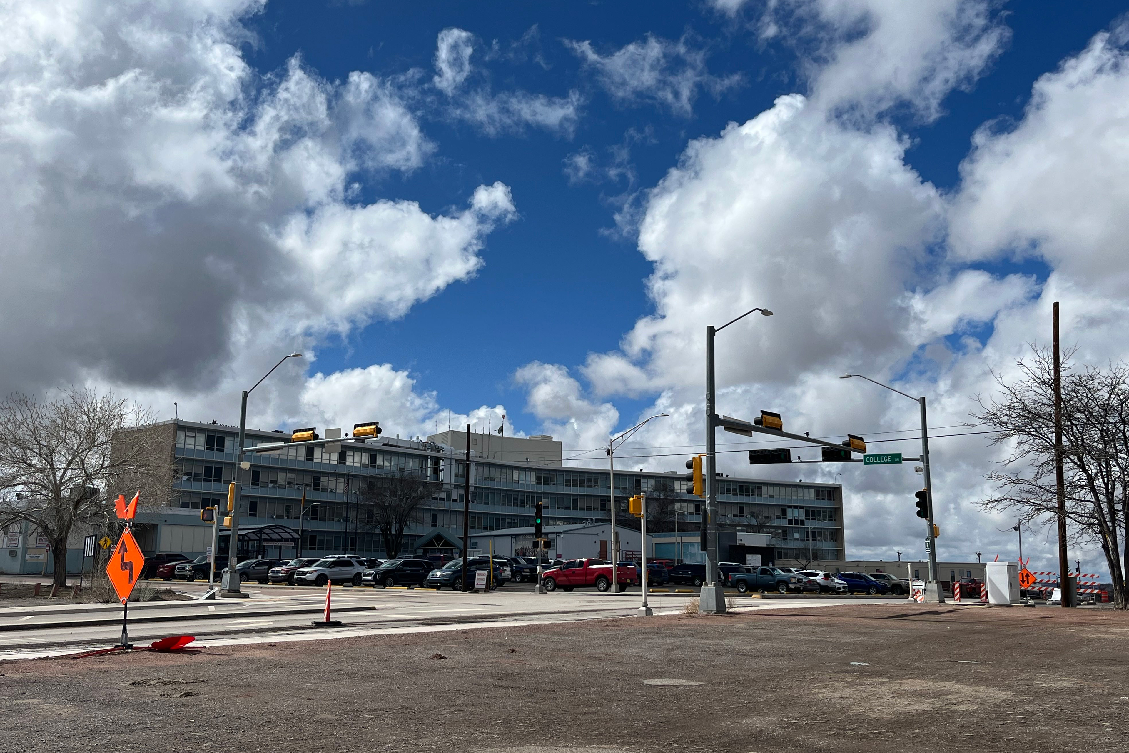 A large building, a medical center, at the intersection of two roads.