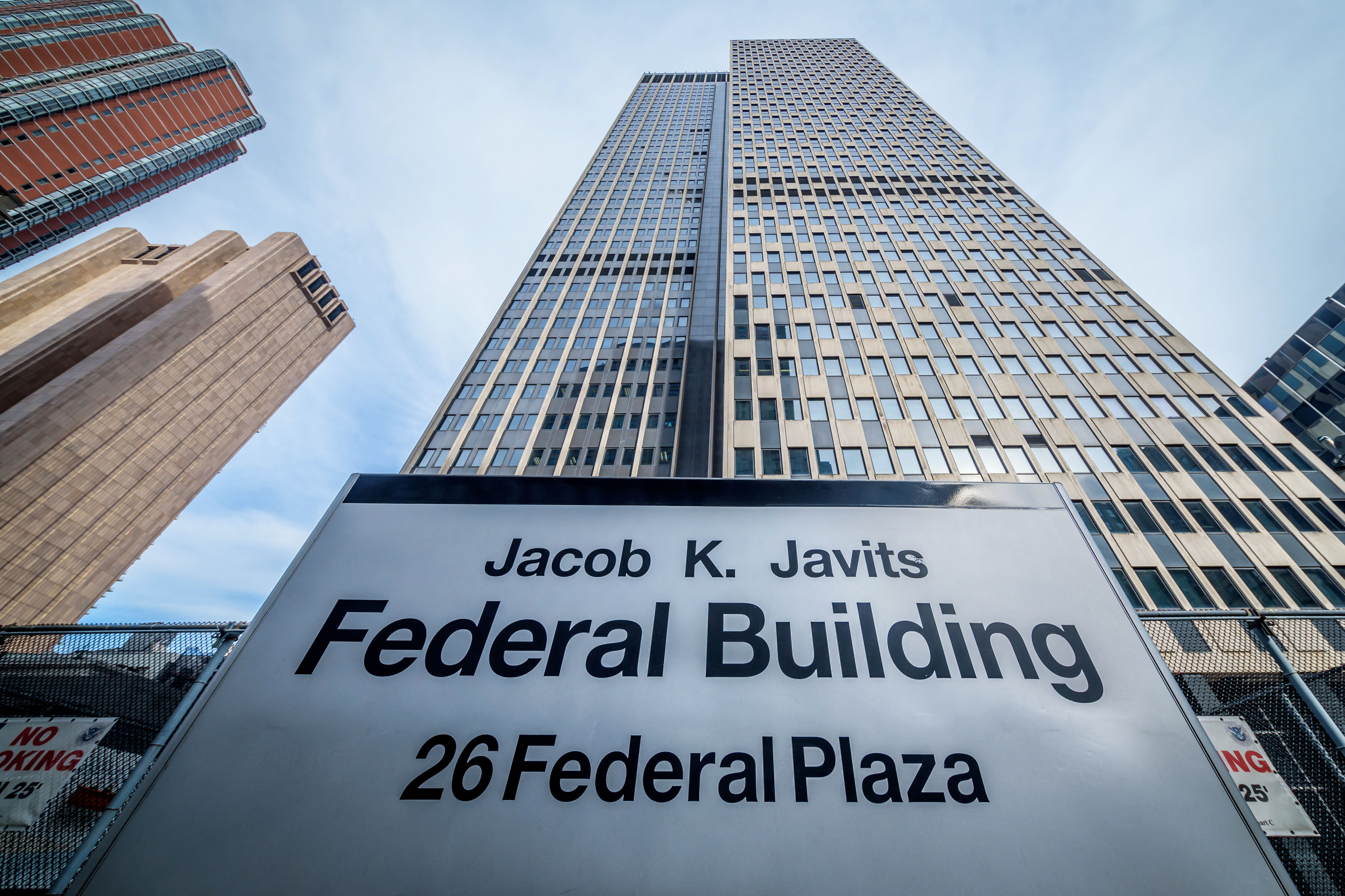 A photo looking up at the Jacob K. Javits Federal Building at 26 Federal Plaza. It is a tall skyscraper in New York City.