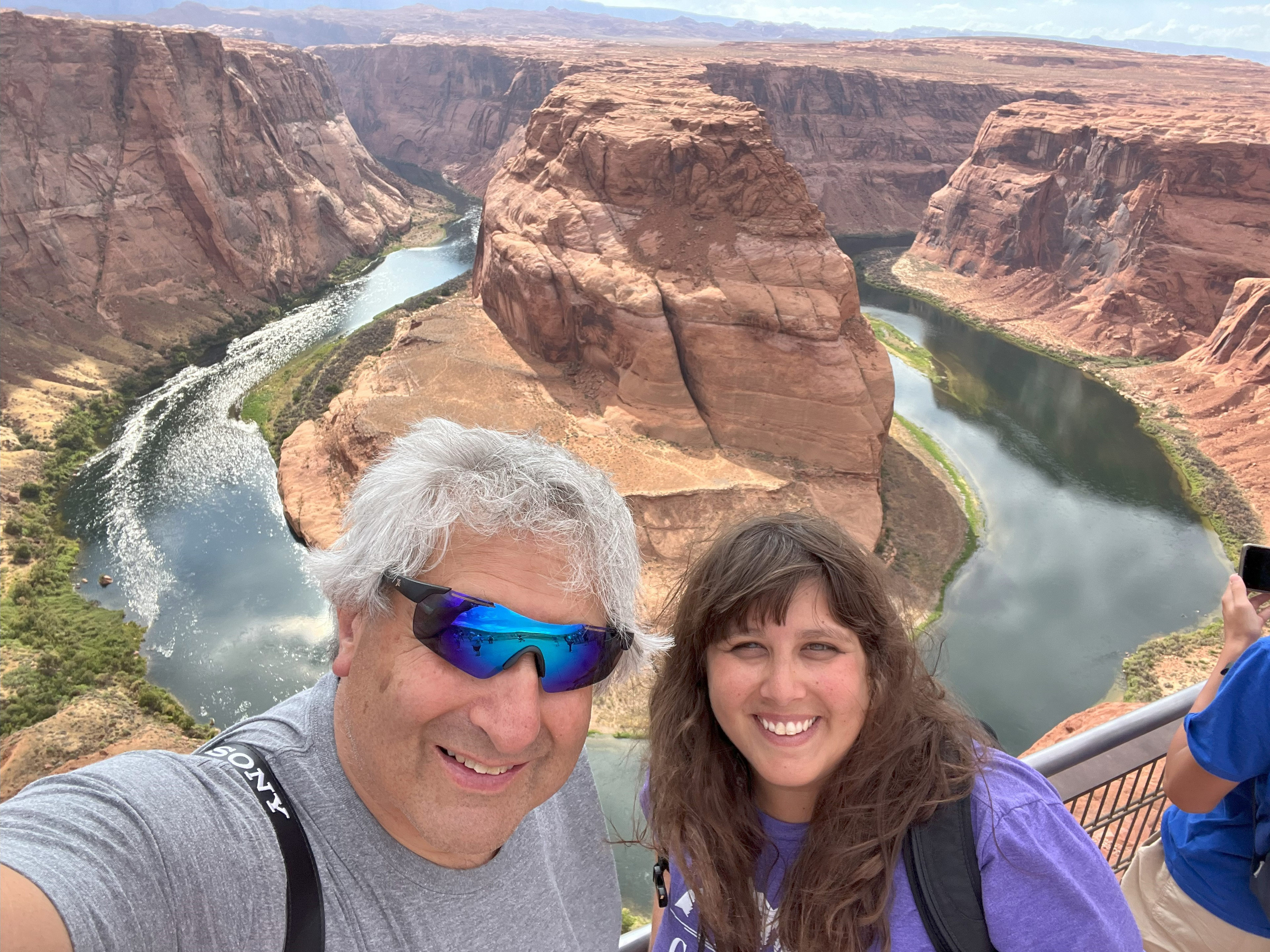 A photo of a father and daughter taking a selfie together at a canyon.